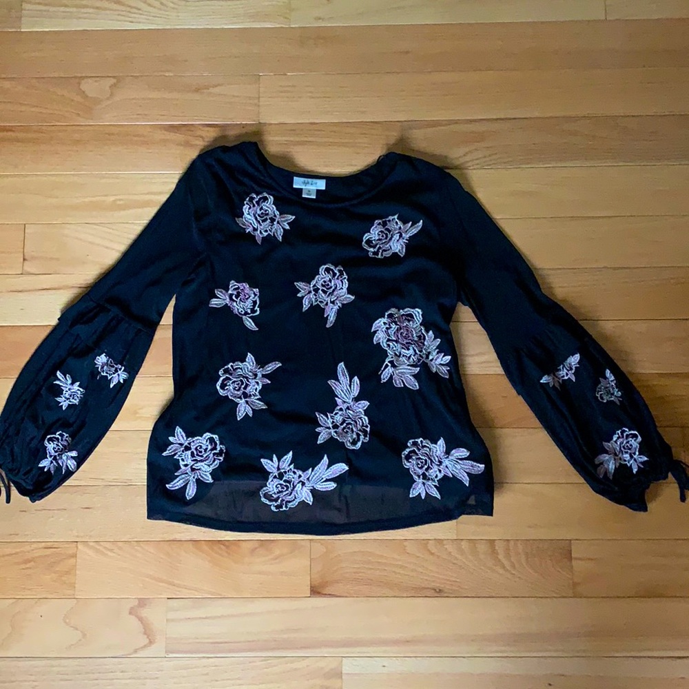 Black top with embroidered flowers